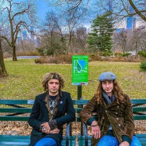 two men sitting on a bench